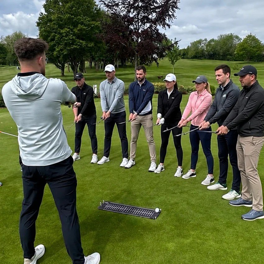 Fairway Legends Academy group coaching session on the practice green